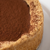 close up of chocolate tart with cocoa powder topping