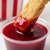 Dipped cookie stick in red raspberry jam 