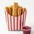 Baked cookie fries in a red and white striped container with a side of raspberry jam on a white background