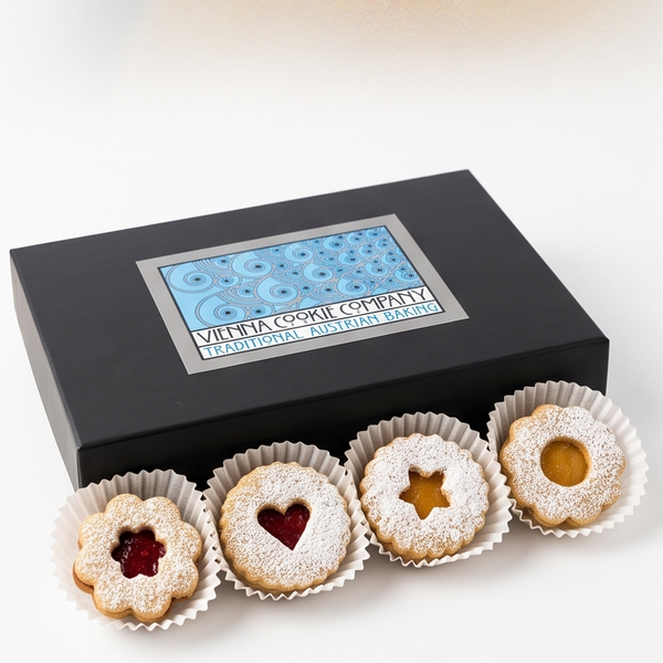 A black gift box of Vienna Cookie Company Linzer Cookies, shown with four cookies in front