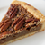 Slice of pecan pie on a white plate