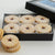 A box wit Raspberry Linzer Cookies