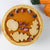 A pumpkin Mousse Pie with sugar glazed cranberries and shortbread cookies as toppings